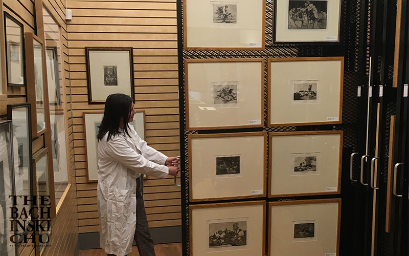 Students examining fine art prints in the collection