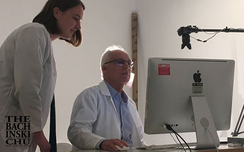 Students examining fine art prints in the collection